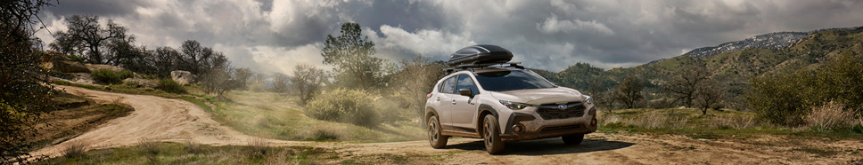 Subaru Crosstrek Hybrid combining outdoor adventure with fuel-efficient performance on a dirt trail