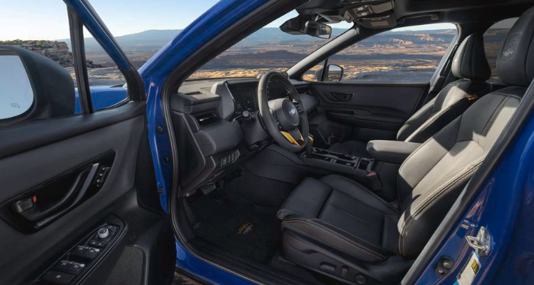 Interior major of the 2026 Outback Wildnerness in Geyser Blue with Slate Black Nappa Leather upholstery. View of the driver's seat area through the open driver's side door.