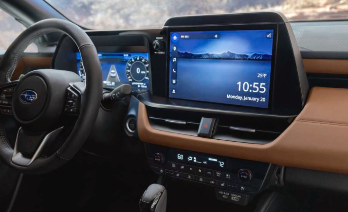 Interior feature image of the multimedia touchscreen and the physical climate control buttons in the 2026 Outback Touring with Java Brown Nappa Leather upholstery.
