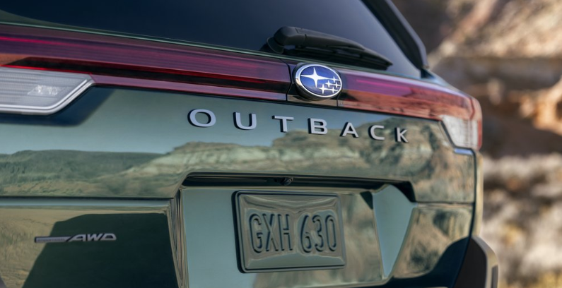 Exterior static feature of the rear gate and badging of the 2026 Outback Touring in Deep Emerald Pearl. Exterior static feature of the rear gate and badging of the 2026 Outback Touring in Deep Emerald Pearl.